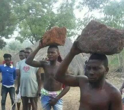 Thieves forced to carry rocks on their heads after being caught stealing.