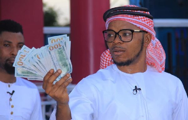 Obinim flashes US$100 notes to celebrate release on bail